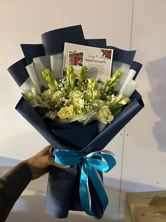 White rose and tuberose anniversary bouquet wrapped in navy with personalized photo card — Moonlit Vow by Flower House Lahore