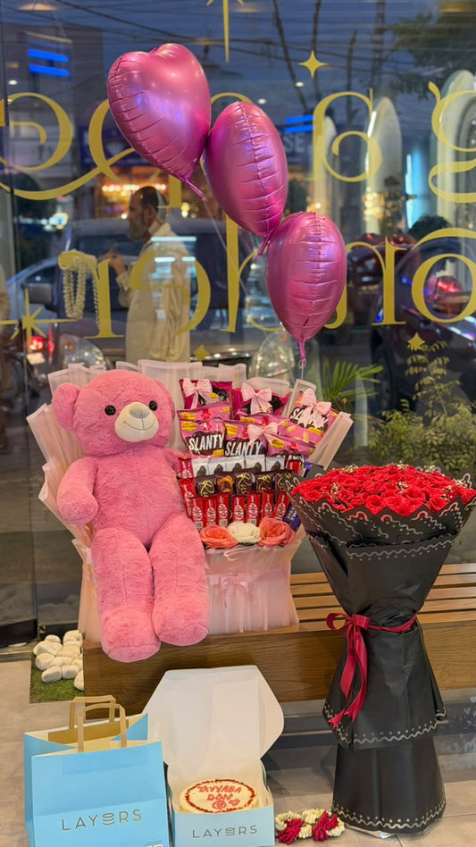 Pink teddy bear with snack bouquet, red rose bouquet, pink heart balloons and personalized cake — gift combo by Flower House Lahore
