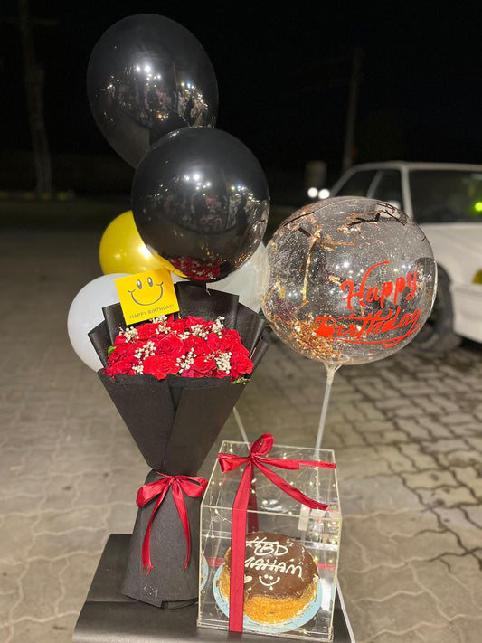 Red rose bouquet, black and gold balloons, confetti bubble balloon and personalized birthday cake — Crimson Confetti combo by Flower House Lahore