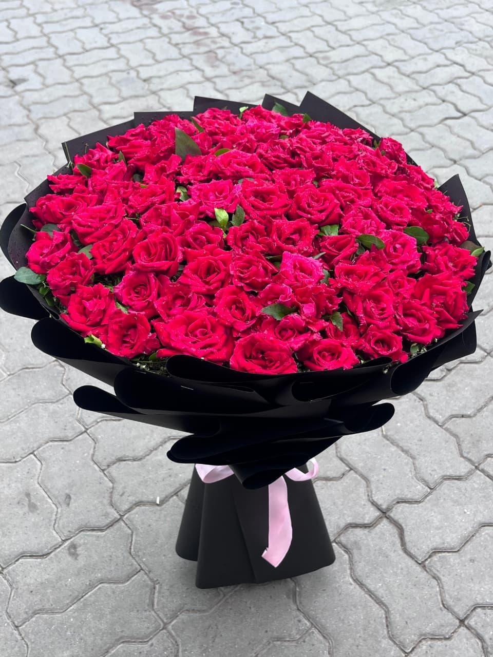 Red Lovebug Bouquet with 100 fresh premium red roses and elegant black wrapping