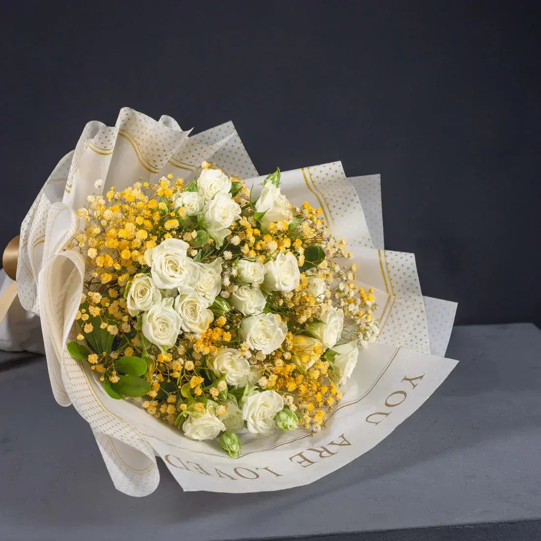 Close-up of white roses and yellow flowers