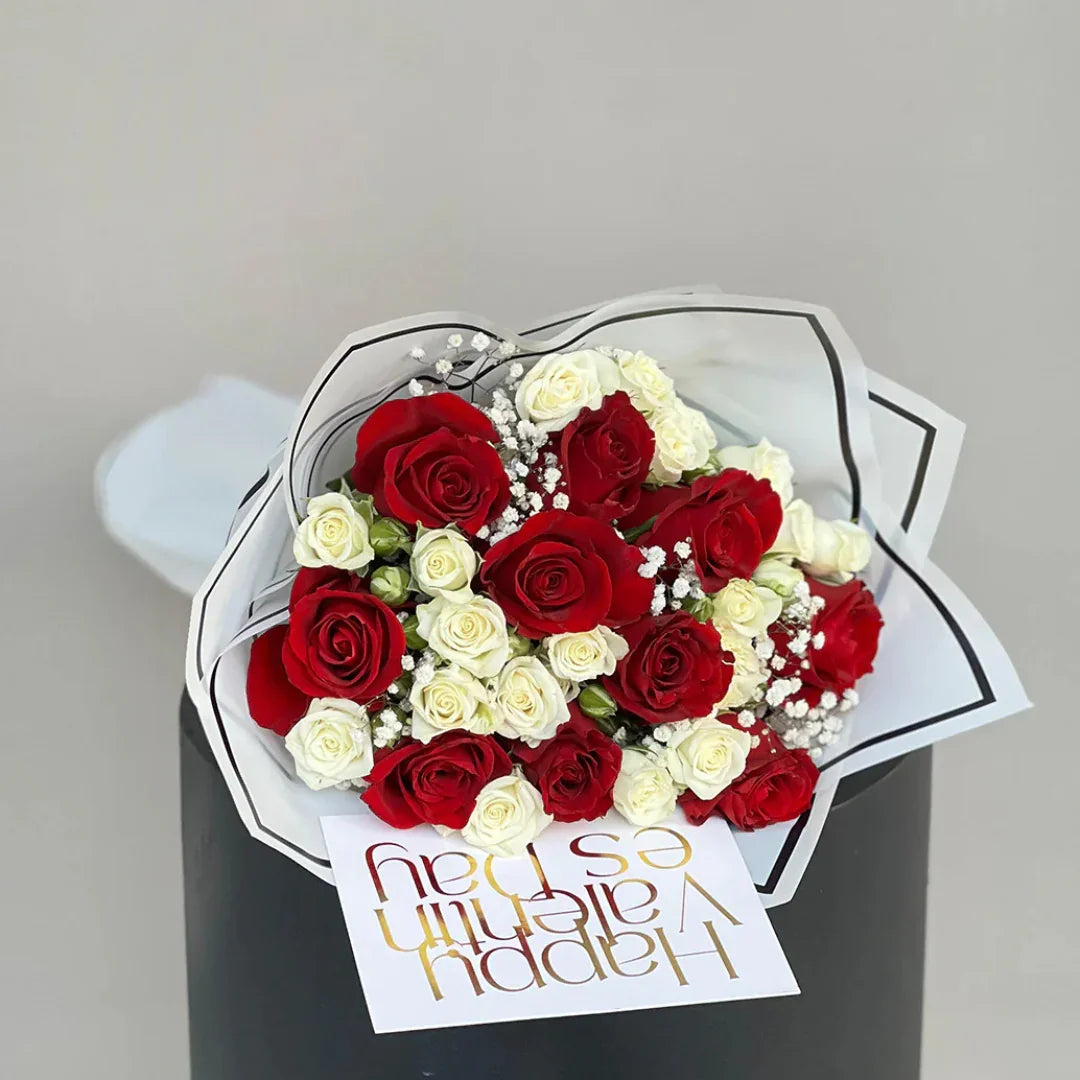 Close-up of red and white roses in Love You bouquet, neutral wrap