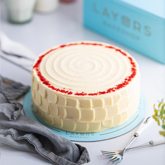 Authentic Layers Red Velvet Cake featuring rich cream cheese frosting on soft red velvet sponge cake layers